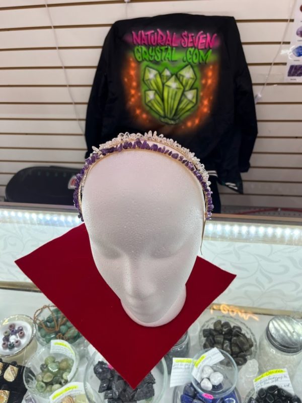 A white mannequin head with some beads on it