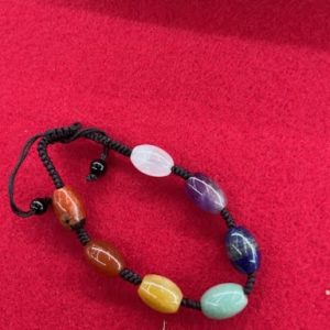 A bracelet with different colored stones on it.