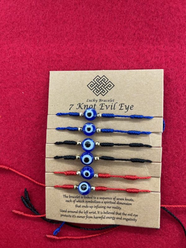 A card with six different colored evil eye bracelets.