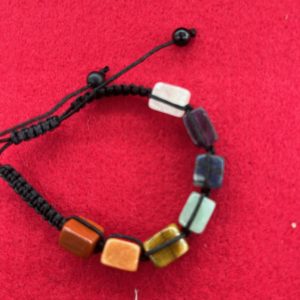 A bracelet with different colored beads on it.