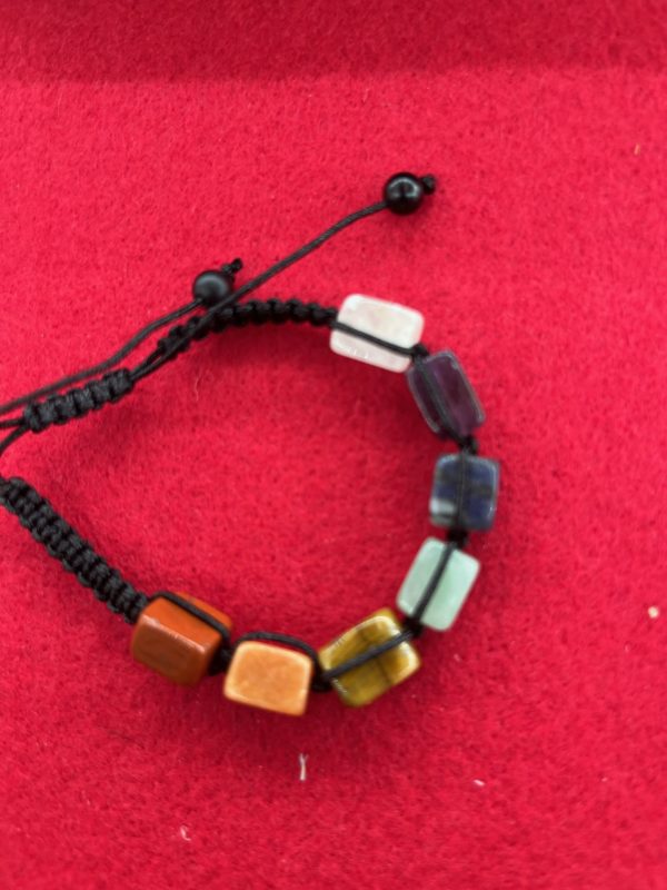 A bracelet with different colored beads on it.