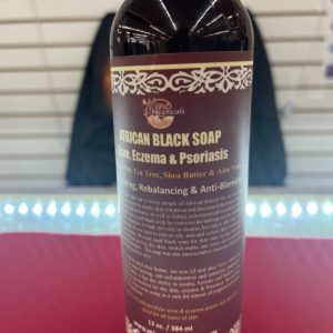 A bottle of black soap sitting on top of a table.