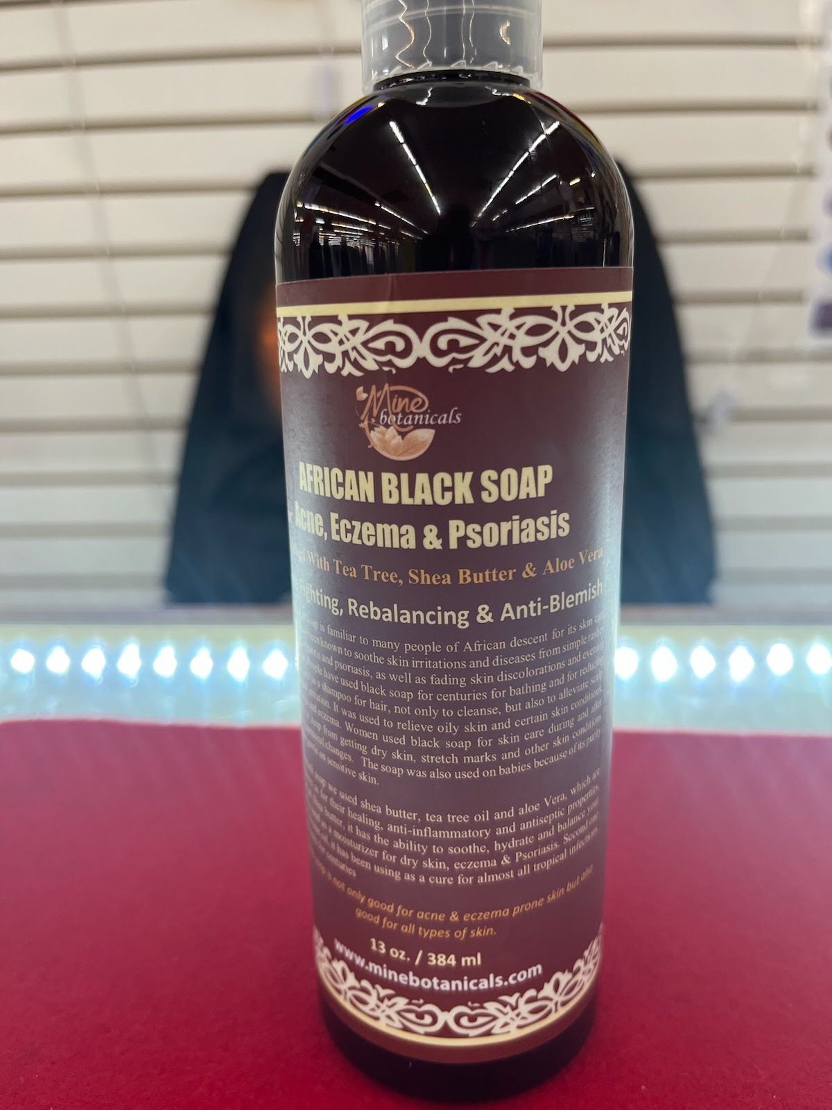 A bottle of black soap sitting on top of a table.