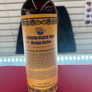 A bottle of african black soap sitting on top of a table.