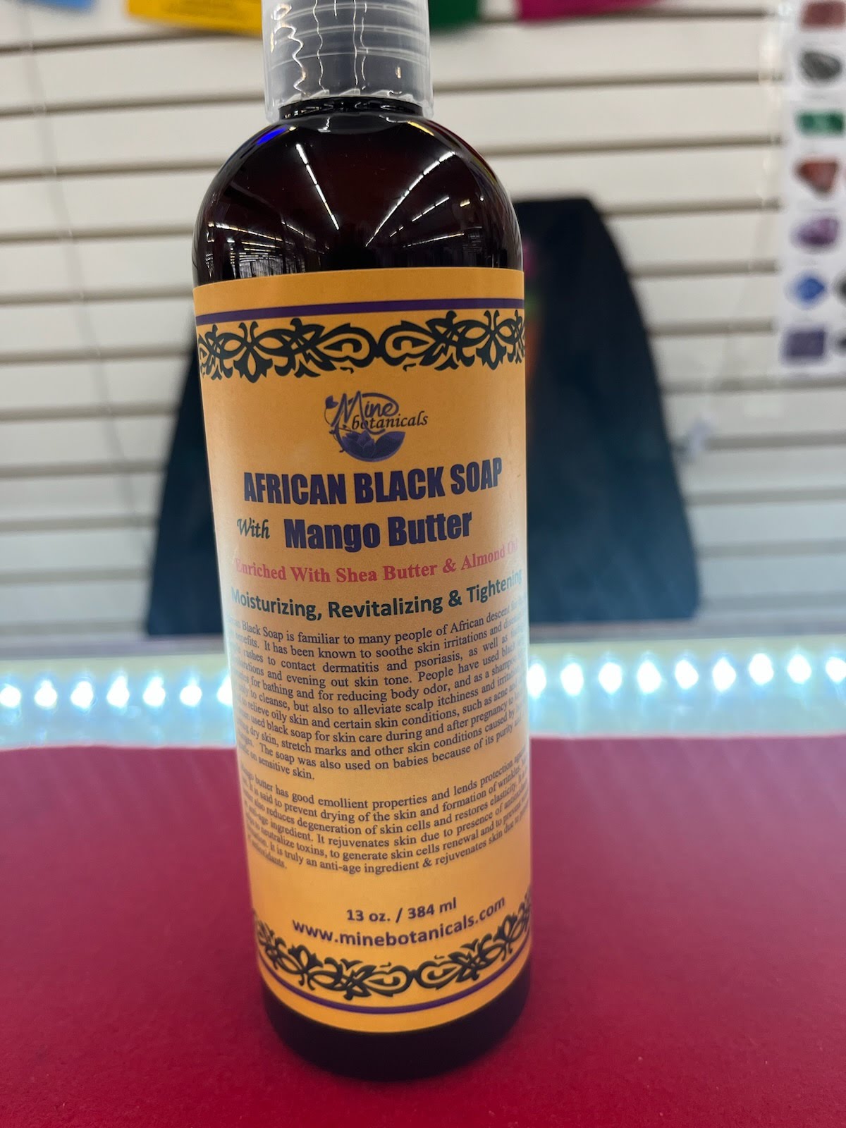 A bottle of african black soap sitting on top of a table.