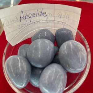 A bowl of blue stones with a note on the side.