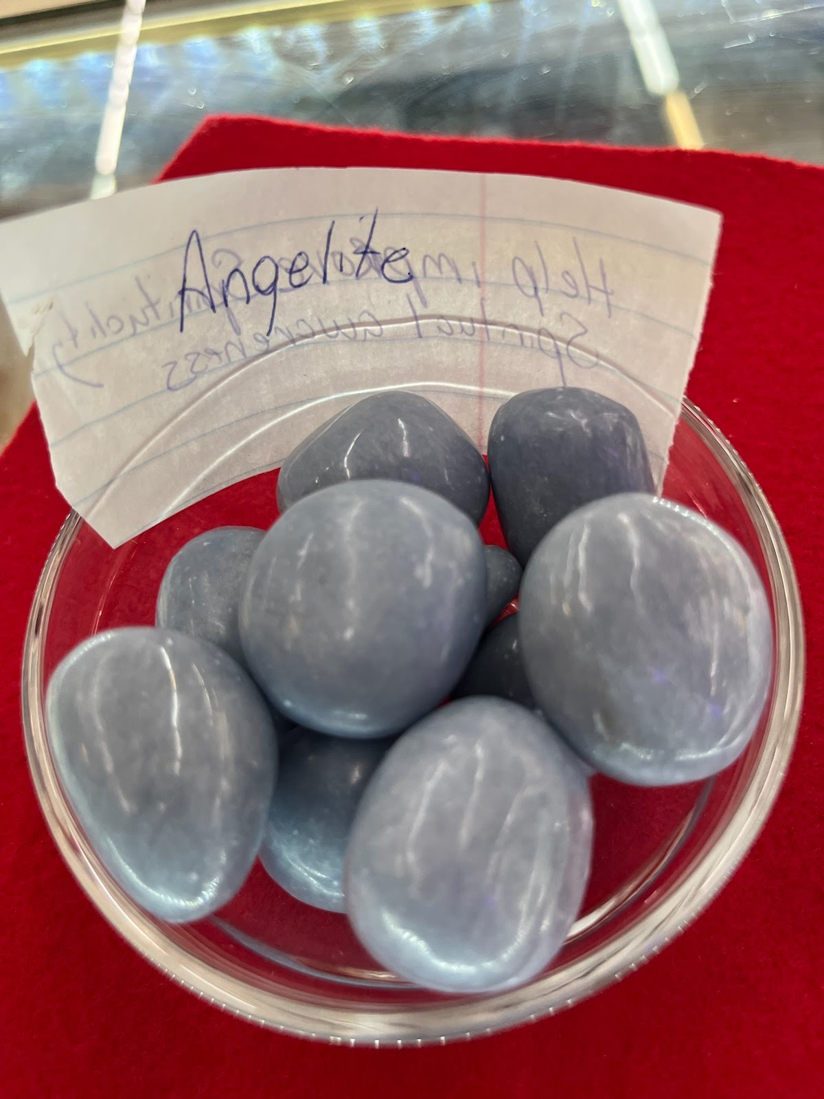 A bowl of blue stones with a note on the side.
