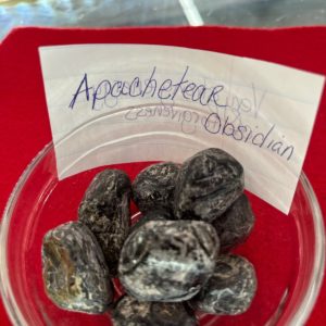 A bowl of black and white rocks with a note.