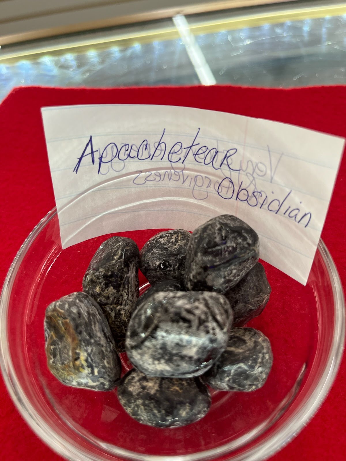 A bowl of black and white rocks with a note.