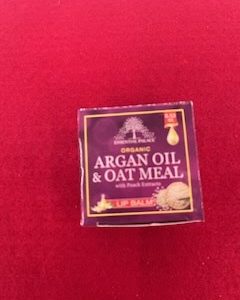 A box of argan oil and oat meal with fresh lemons.