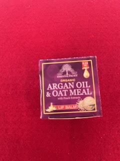 A box of argan oil and oat meal with fresh lemons.