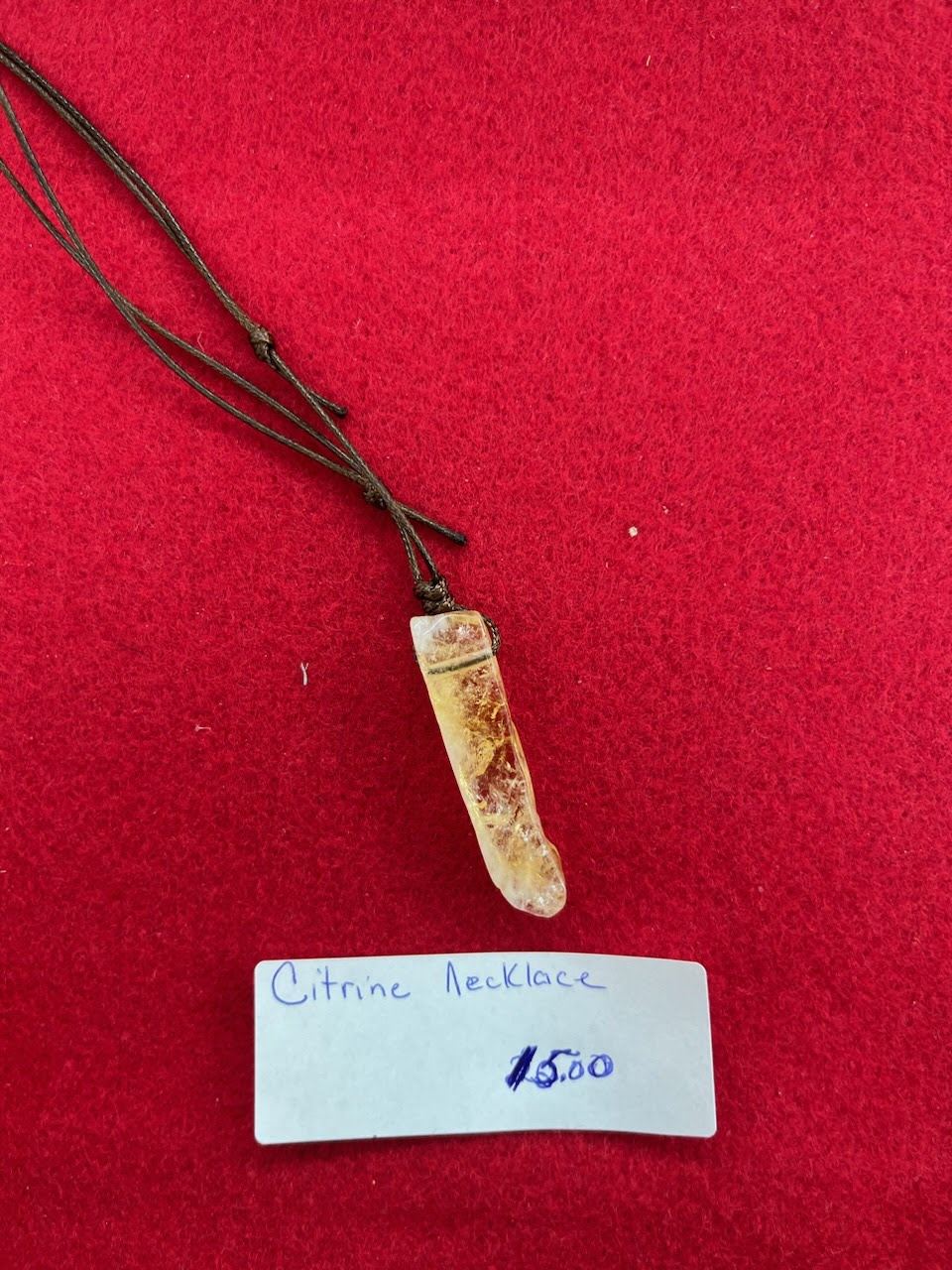 A small bone necklace on a red cloth