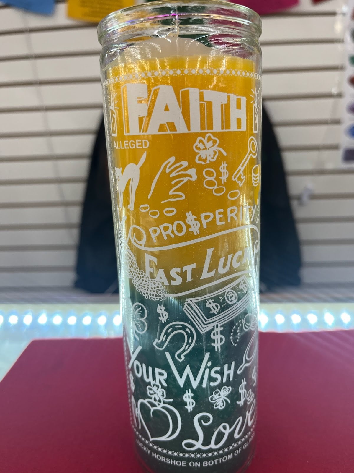 A glass with the words " faith, prosperity, fast luck ," and " our wish ".