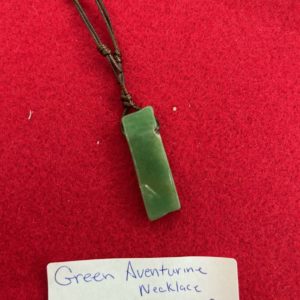 A green aventurine necklace is shown on a red background.