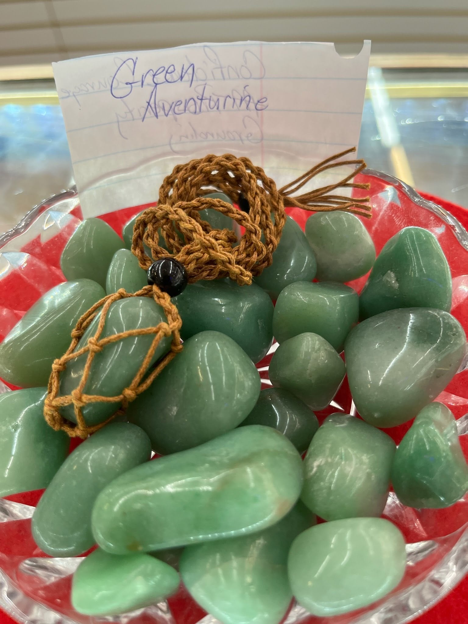 A bowl of green aventurine rocks and beads.