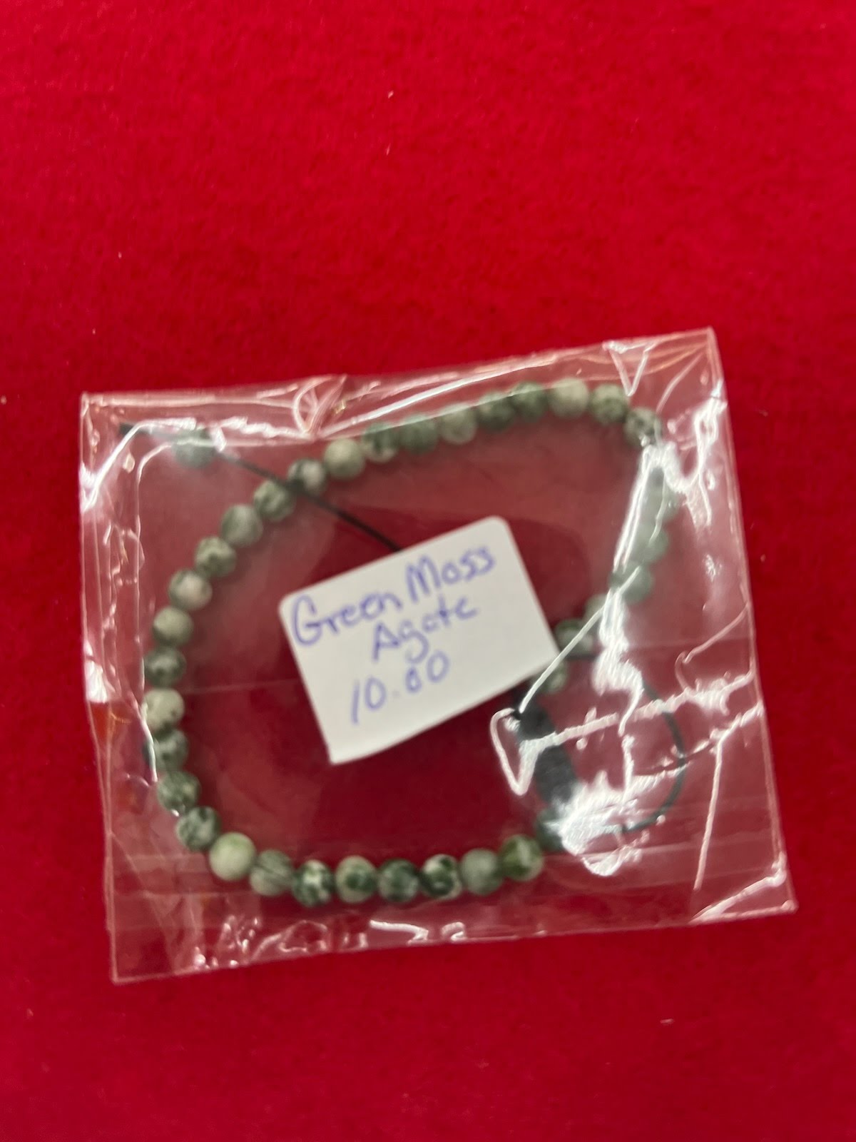 A small bag of jewelry with a tag on it.
