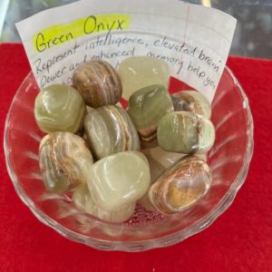 A bowl of green onyx with a note on it.