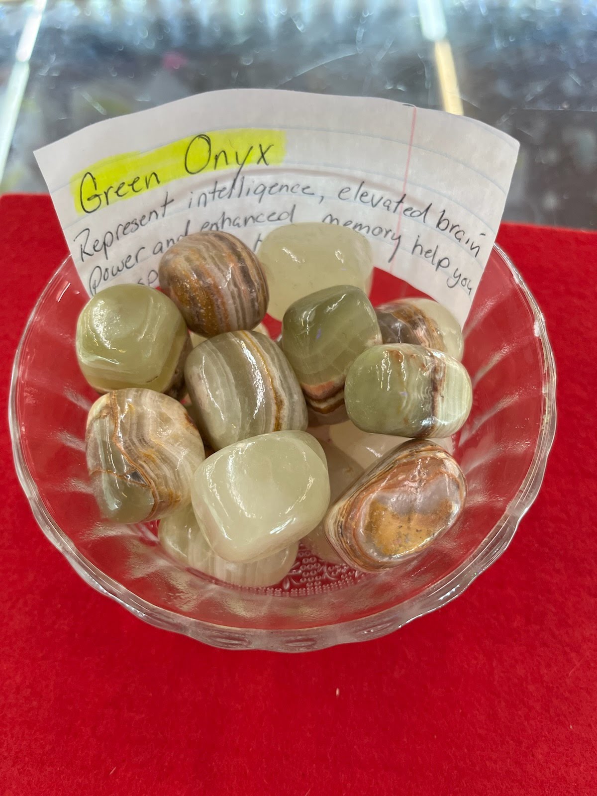 A bowl of green onyx with a note on it.