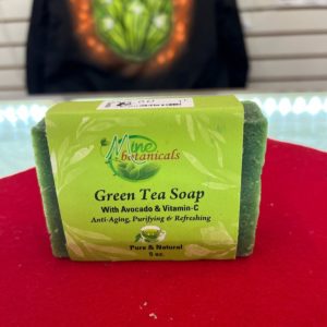 A green tea soap sitting on top of a red table.