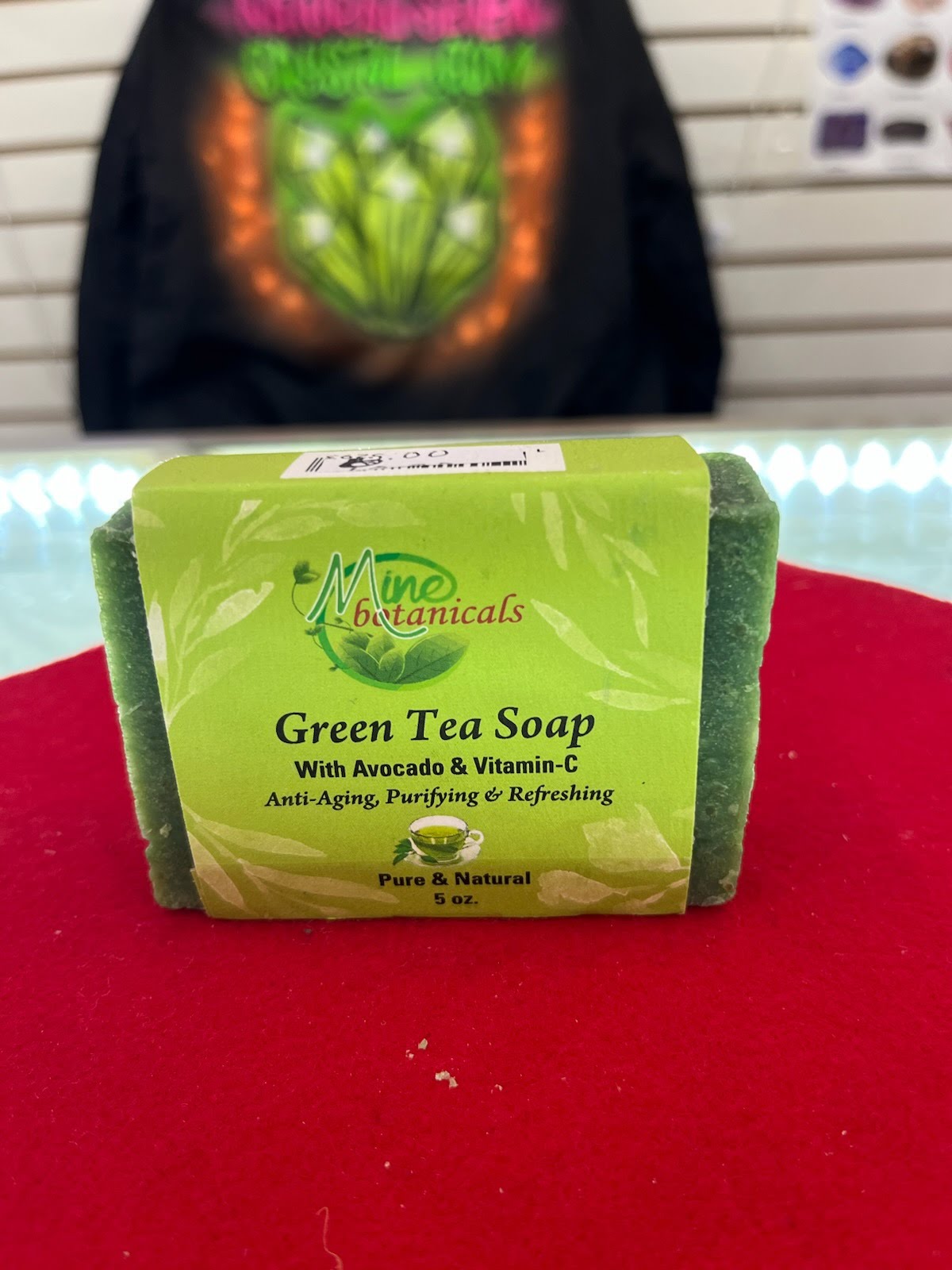 A green tea soap sitting on top of a red table.