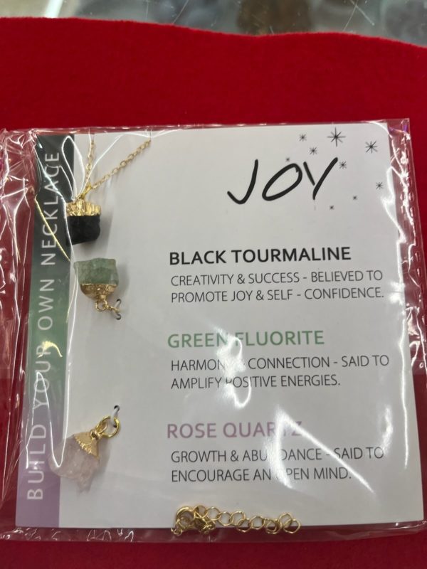 A package of jewelry with the word joy on it.