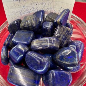 A bowl of blue stones on top of a table.