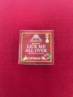 A red box of lip balm with the words " lick me all over ".