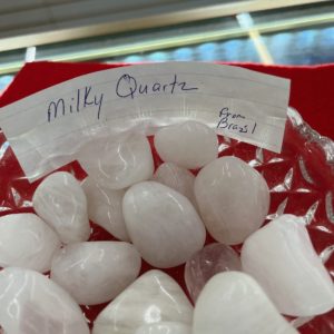 A red basket filled with lots of white rocks.