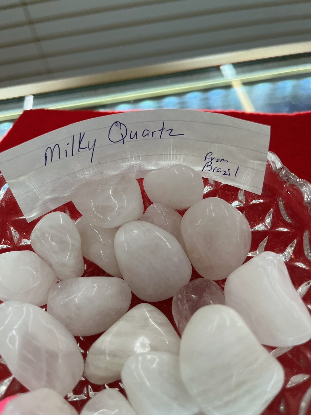 A red basket filled with lots of white rocks.