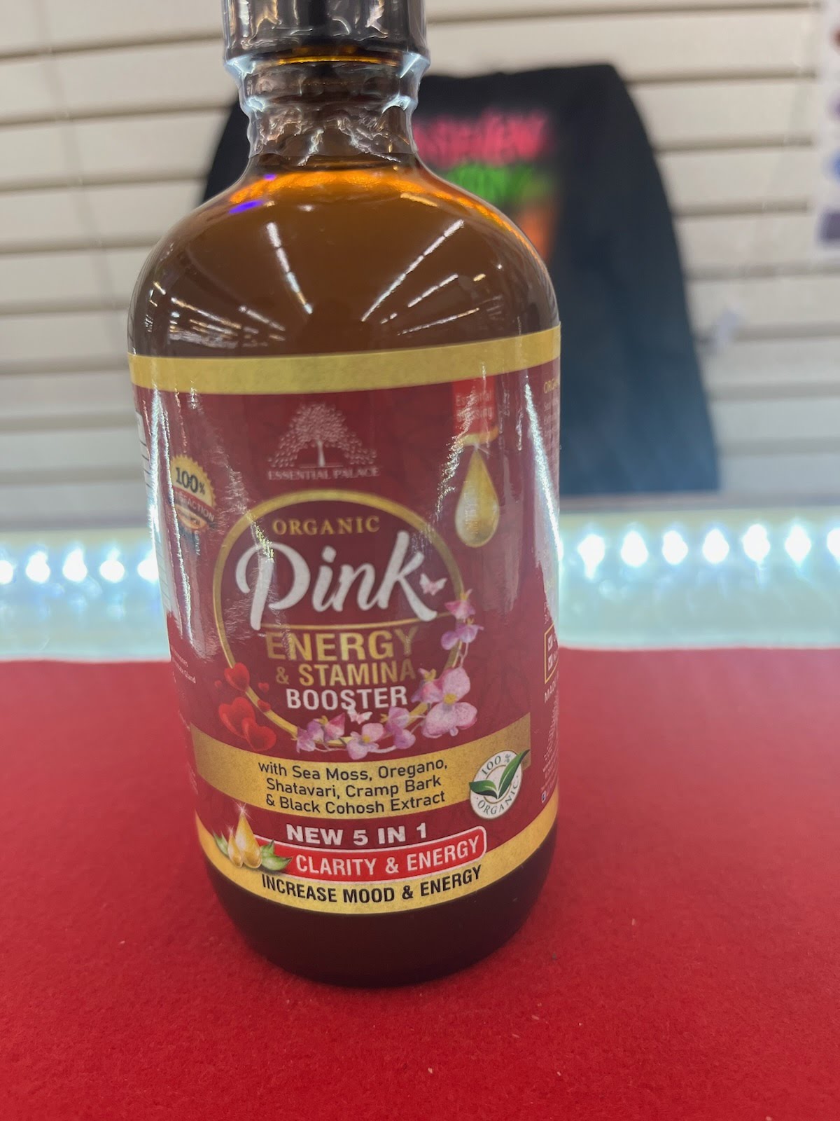 A bottle of pink 's energy booster on top of a table.
