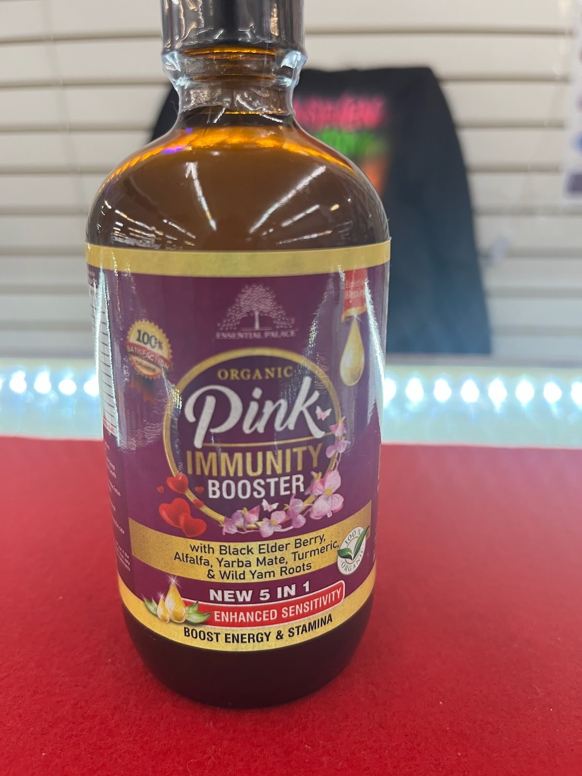 A bottle of pink immunity booster on a table.