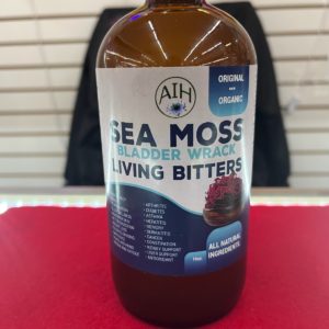 A bottle of sea moss is sitting on the table.