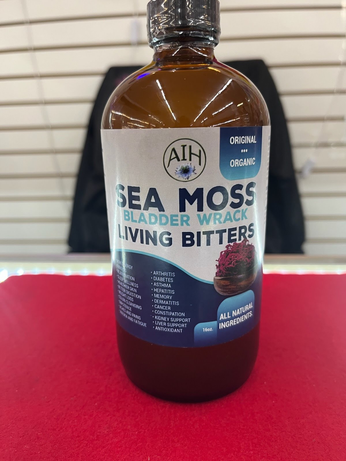 A bottle of sea moss is sitting on the table.