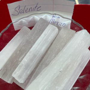 Selenite sticks are sitting on a plate.