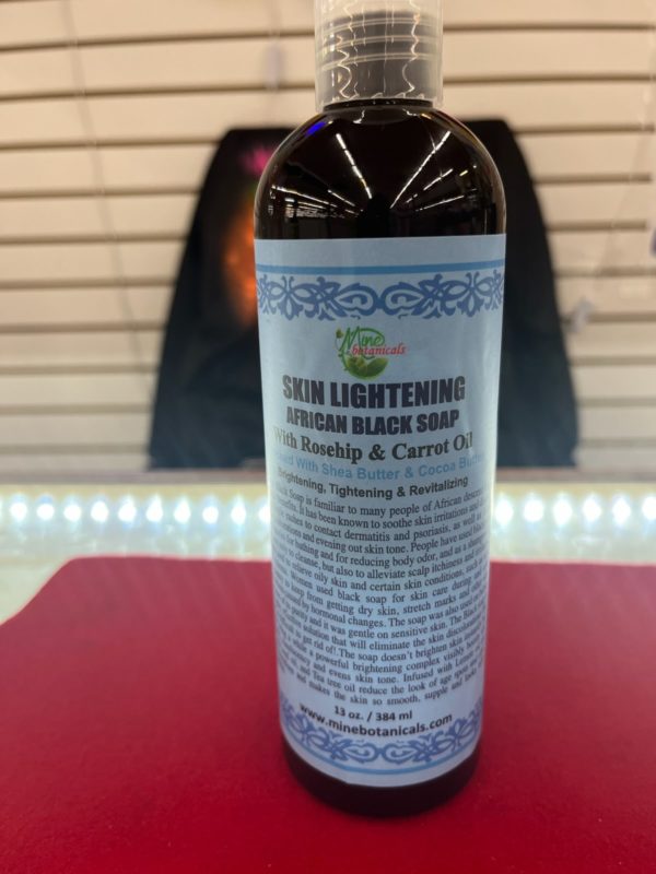 A bottle of black soap sitting on top of a counter.