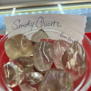 A bowl of smoky quartz is sitting on the table.