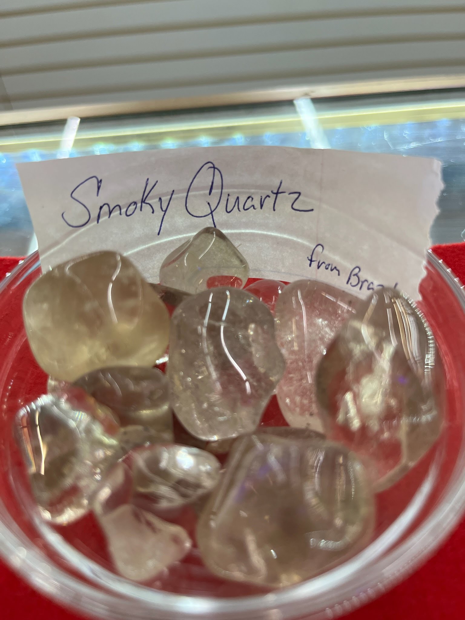 A bowl of smoky quartz is sitting on the table.