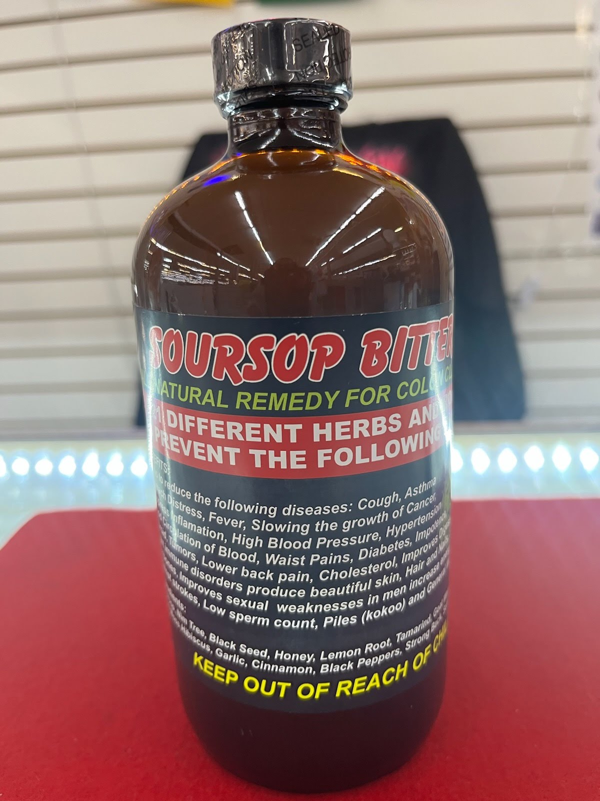 A bottle of bursop syrup sitting on top of a table.