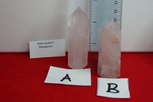 A pink quartz crystal and two other crystals