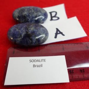 A pair of sodalite stones with a ruler and name card.