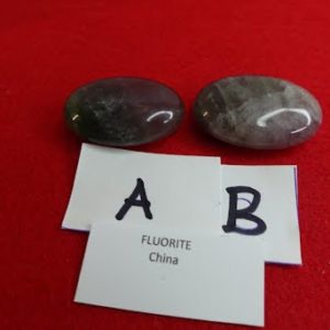 Two rocks and a card with the letters ab and fluoride