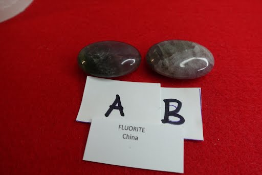 Two rocks and a card with the letters ab and fluoride