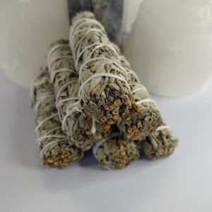 A stack of white sage sticks sitting on top of a table.