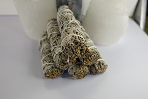 A stack of white sage sticks sitting on top of a table.