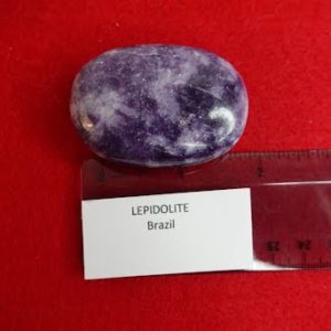 A purple stone sitting on top of a red surface.