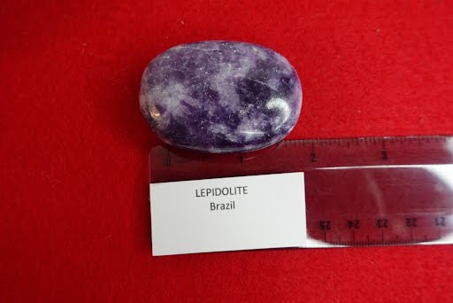 A purple stone sitting on top of a red surface.
