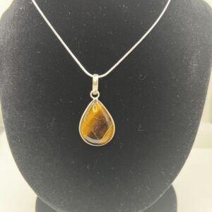 A necklace with a tiger eye stone on it