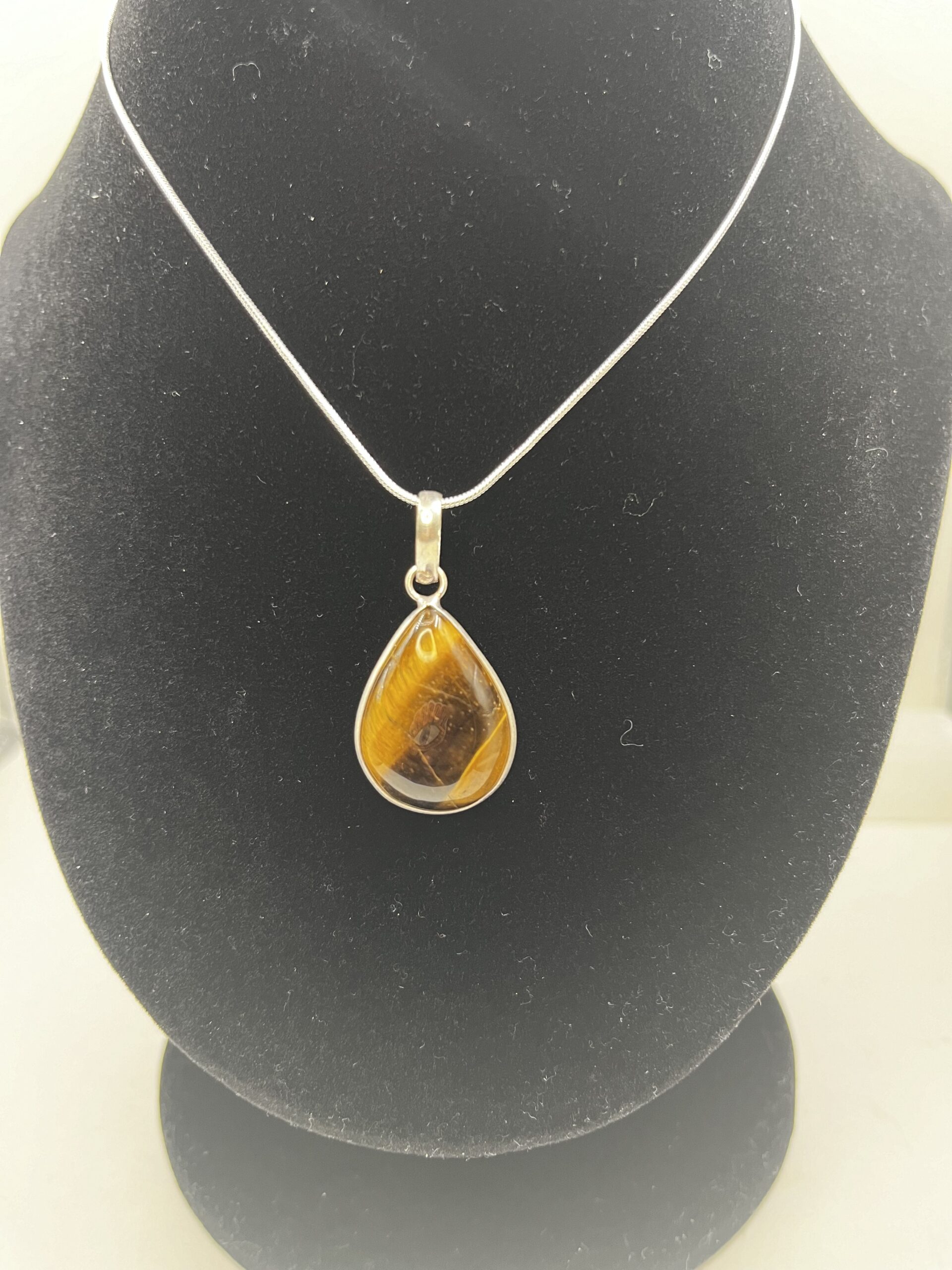 A necklace with a tiger eye stone on it